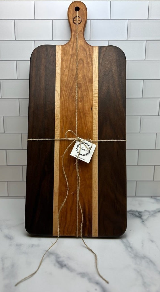 Wooden Charcuterie Board with a Willow Board logo on a marble surface and tiled wall background