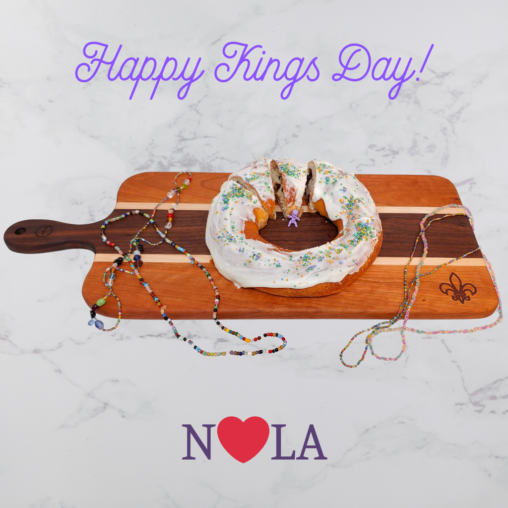 Willow Wood Charcuterie Board with a King Cake on it and engraved with a fleur-de-lis.