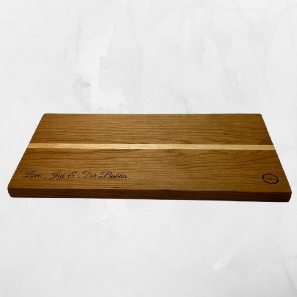 Wood cheese board with personalized engraving on white background