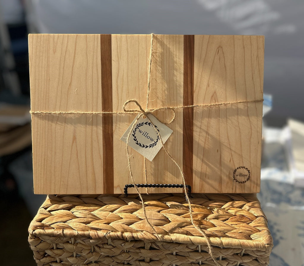 Small cheese board made of Vermont Maple sitting on a basket.