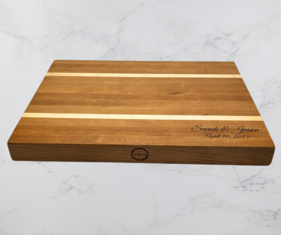 Wooden cutting board that is custom engraved on a white marble background