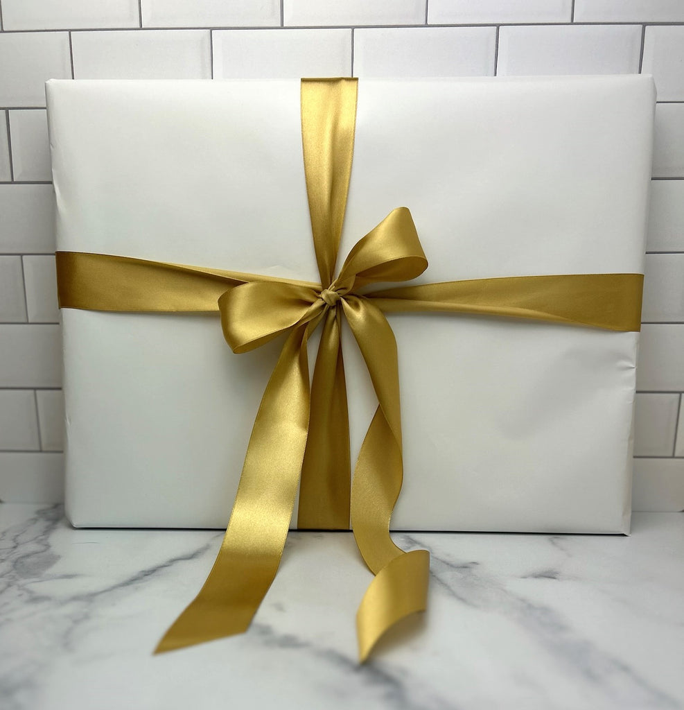 Willow Cutting Board gift wrapped with white shiny paper and gold stain ribbon.