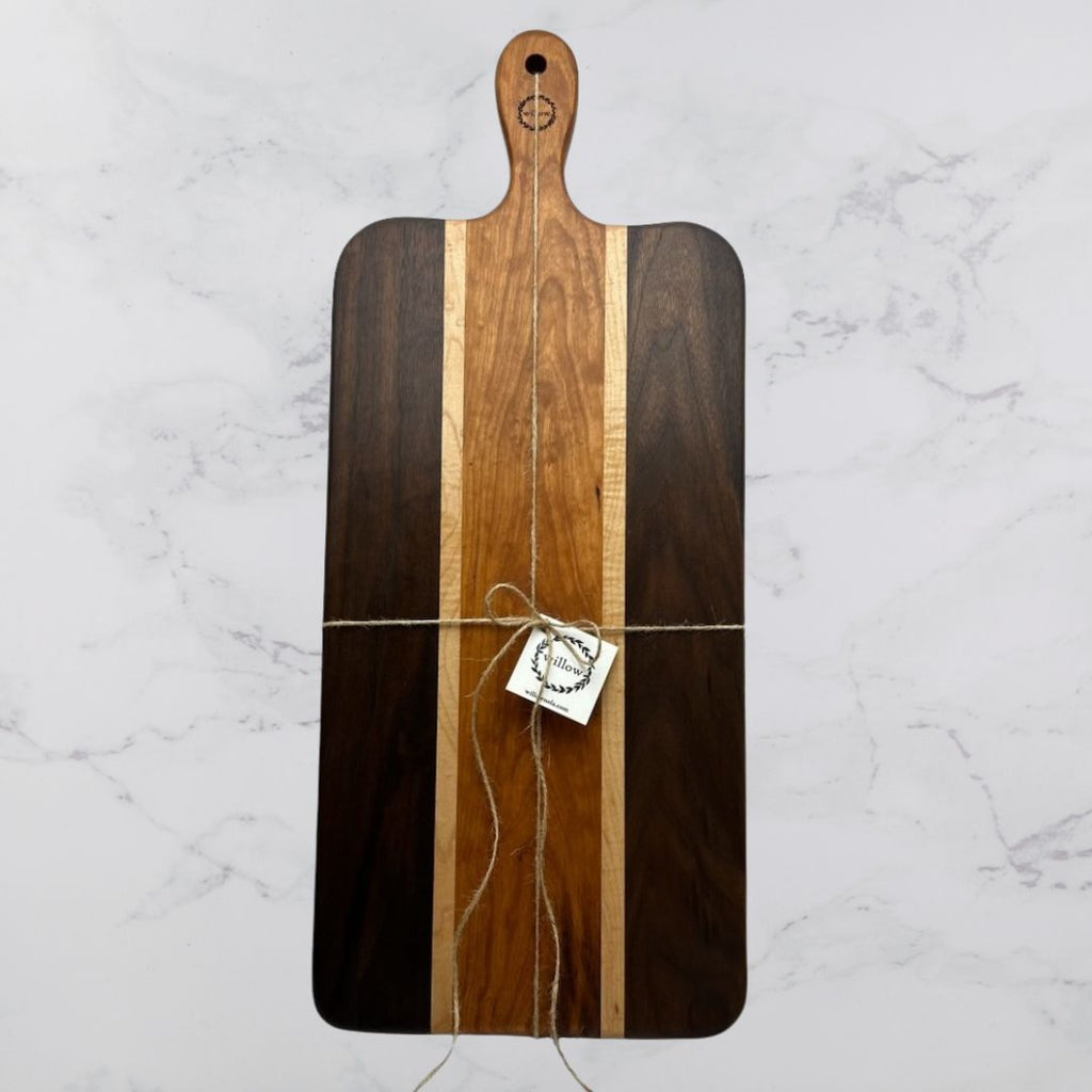 Wooden Charcuterie Board with a Willow Board logo and twine on a marble background