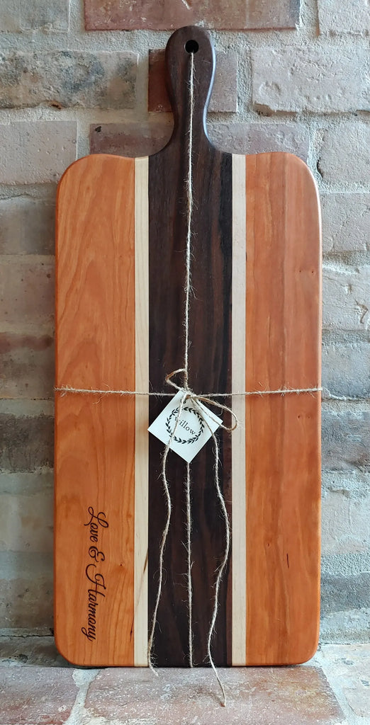 Engraved Charcuterie Board made of Vermont cherry and walnut on old brick fireplace.